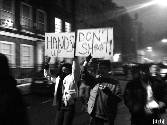 Protestors holding signs that say "Hands up Don't Shoot!"